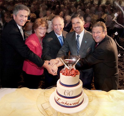Lakewood's 60th Anniversary cake being cut by City Council Members (from left) Jeff Wood, Diane DuBois, Steve Croft, Todd Rogers, and Ron Piazza