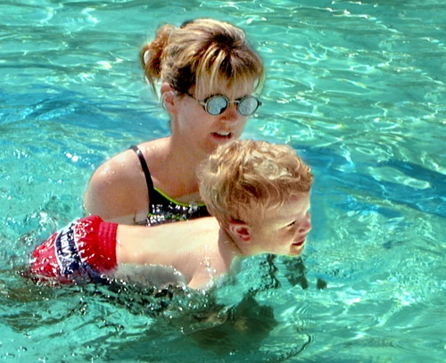 Adult instructor and child in pool