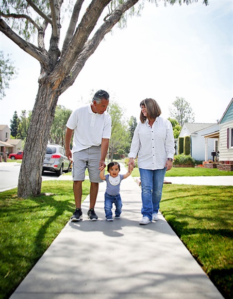 Two adults walking with a child