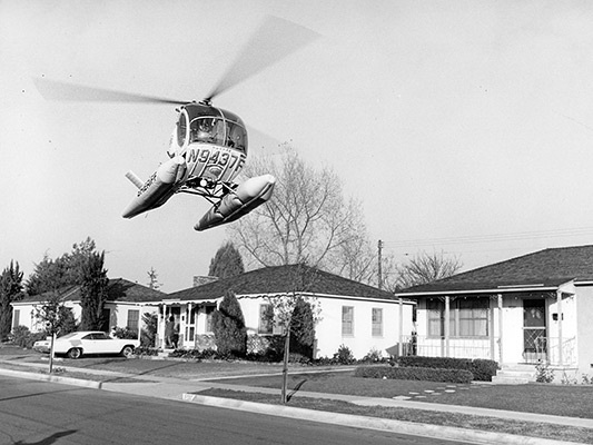 Sky Knight helicopter (1966) flys over neighborhood