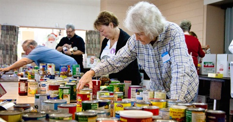 People sorting canned goods for Project Shepherd