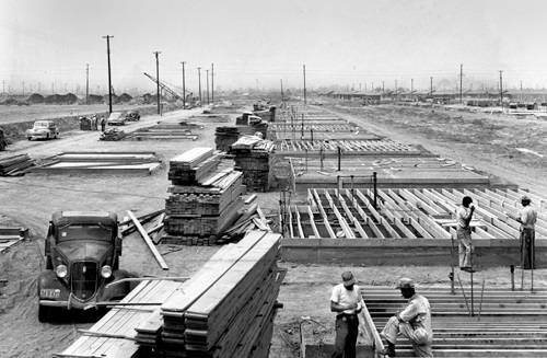 Homes under construction with lumber and other supplies piled up