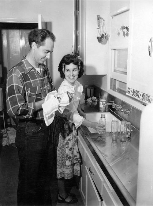 Young couple washing dishes