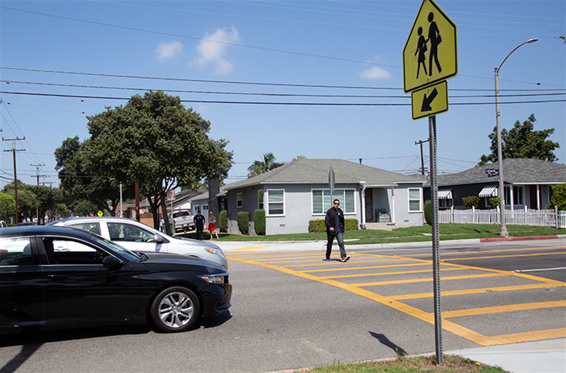Cars stopped while pedestrian crosses street
